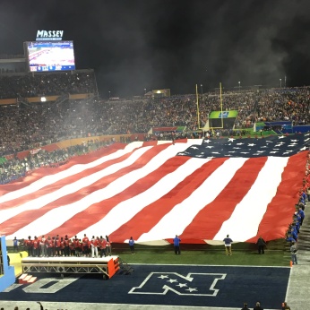 AMERICAN FLAG BEING UNFURLED AT A FOOTBALL GAME. PHOTO SENT TO ME BY MY SISTER AND HER HUSBAND.