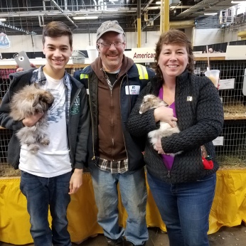 DYLAN, JEFF AND ANGELA AT THE FARM SHOW WITH THEIR SHOW RABBITS.